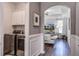 Hallway with a laundry room and arched entry, offering a seamless blend of style and functionality at 2880 Cavalcade Cir, Johns Island, SC 29455