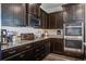 Gourmet kitchen with granite countertops, dark wood cabinetry, and stainless steel appliances at 2880 Cavalcade Cir, Johns Island, SC 29455