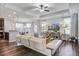 Bright living room showcasing recessed lighting, modern ceiling fan, white sofa, and an open-concept design at 2880 Cavalcade Cir, Johns Island, SC 29455