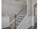 Elegant staircase featuring decorative iron railings and wood accents at 2880 Cavalcade Cir, Johns Island, SC 29455