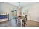 Bright dining room features an antique dresser, a modern cabinet, and wood floors at 293 Firewheel Ct, Summerville, SC 29486