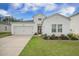 Charming one-story home with attached garage, beautiful landscaping, and a well-manicured lawn at 293 Firewheel Ct, Summerville, SC 29486