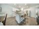 Modern kitchen with an island featuring a sink, stainless steel refrigerator, and granite countertops at 293 Firewheel Ct, Summerville, SC 29486