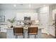 Open kitchen with large island, stainless appliances, white cabinets and granite counters at 293 Firewheel Ct, Summerville, SC 29486