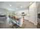An open kitchen features stainless appliances, granite countertops, and a view into the dining area at 293 Firewheel Ct, Summerville, SC 29486