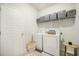 Bright laundry room featuring a washer, a dryer, and shelving for storage at 293 Firewheel Ct, Summerville, SC 29486