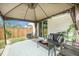Relaxing covered outdoor patio with furniture, perfect for enjoying the backyard at 293 Firewheel Ct, Summerville, SC 29486
