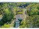Aerial view of house nestled among trees on a well-maintained street with pool, landscaping, and neighbor homes at 3001 Grand Bay Ln, Johns Island, SC 29455