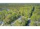 Breathtaking aerial view of a home near the water, nestled in a lush, green forest at 3001 Grand Bay Ln, Johns Island, SC 29455