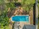 Aerial shot showcases a backyard pool and a wooden deck with furniture; lush greenery surrounds the property at 3001 Grand Bay Ln, Johns Island, SC 29455