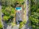 A captivating aerial view of a well-maintained property with a refreshing pool, set amidst lush greenery and a peaceful street at 3001 Grand Bay Ln, Johns Island, SC 29455