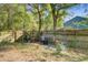 Private backyard with natural landscaping, wood fence, and a charming area for outdoor seating and relaxation at 3001 Grand Bay Ln, Johns Island, SC 29455