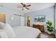 This light and airy bedroom offers a TV, ceiling fan, barn door, and en suite bath at 3001 Grand Bay Ln, Johns Island, SC 29455