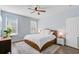 Sun-filled bedroom with hardwood floors, a large bed, two windows, and a nightstand at 3001 Grand Bay Ln, Johns Island, SC 29455