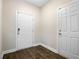 Hallway with wood flooring, white doors, and a neutral color scheme at 3001 Grand Bay Ln, Johns Island, SC 29455