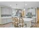 Bright kitchen featuring a center island with quartz countertops, pendant lighting, gray cabinetry, and stainless steel appliances at 3001 Grand Bay Ln, Johns Island, SC 29455