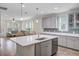 Kitchen with an island sink, stainless appliances, white countertops, and a casual seating area at 3001 Grand Bay Ln, Johns Island, SC 29455