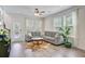 Cozy living room featuring hardwood floors, a gray sectional sofa, and access to the outdoor patio at 3001 Grand Bay Ln, Johns Island, SC 29455