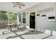 Cozy screened porch with ceiling fan, a sitting area, and an entrance to the house at 3001 Grand Bay Ln, Johns Island, SC 29455