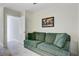 Comfortable sitting room with a plush green sofa and a world map on the wall at 3001 Grand Bay Ln, Johns Island, SC 29455