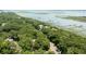 Aerial view showcasing a waterfront community with docks and stately homes surrounded by mature trees at 3023 Maritime Forest Dr, Johns Island, SC 29455