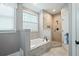 Bathroom with a soaking tub, tiled shower, and natural light at 3023 Maritime Forest Dr, Johns Island, SC 29455