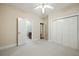Bedroom with carpet, ceiling fan, closet, and view to the bathroom and hallway at 3023 Maritime Forest Dr, Johns Island, SC 29455