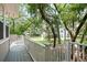A view from the deck of a home with lush landscaping and beautiful trees at 3023 Maritime Forest Dr, Johns Island, SC 29455