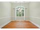 Bright dining room features hardwood floors, chandelier, and large window with elegant windowpane detail at 3023 Maritime Forest Dr, Johns Island, SC 29455