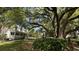 Stunning exterior view with a wraparound porch and an old oak tree, perfect for enjoying the outdoors at 3023 Maritime Forest Dr, Johns Island, SC 29455
