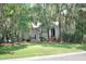 Beautiful home exterior with established landscaping, mature trees and classic architectural details at 3023 Maritime Forest Dr, Johns Island, SC 29455