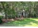 Charming home nestled among mature trees, featuring a classic brick stairway entrance and lush lawn at 3023 Maritime Forest Dr, Johns Island, SC 29455