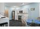 Kitchen featuring white cabinets, stainless appliances, and a glass-top table with four chairs at 3023 Maritime Forest Dr, Johns Island, SC 29455