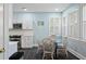 Eat-in kitchen with white cabinets, stainless appliances, and a glass-top table for four at 3023 Maritime Forest Dr, Johns Island, SC 29455