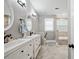 Bright bathroom featuring double vanities, sleek fixtures, and a separate tub at 3023 Maritime Forest Dr, Johns Island, SC 29455