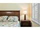 Primary bedroom with a hardwood floor, floral bedding, and plantation shutters at 3023 Maritime Forest Dr, Johns Island, SC 29455