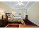 Spacious primary bedroom with hardwood floors, tray ceiling, and door to the outside at 3023 Maritime Forest Dr, Johns Island, SC 29455