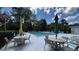 Community pool area with lounge chairs, tables, and umbrellas, perfect for relaxing on a sunny day at 3023 Maritime Forest Dr, Johns Island, SC 29455