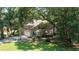 Well-maintained home with a two-car garage, lush lawn and mature trees at 3023 Maritime Forest Dr, Johns Island, SC 29455