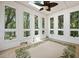Bright sun room with a ceiling fan, tile floor, and multiple windows at 3023 Maritime Forest Dr, Johns Island, SC 29455