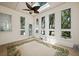 Bright sun room with a ceiling fan, tile floor, and multiple windows at 3023 Maritime Forest Dr, Johns Island, SC 29455