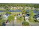 An aerial view highlighting a neighborhood house backing onto a serene lake, framed by lush greenery at 318 Seneca River Dr, Summerville, SC 29485