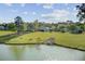 Beautiful backyard with lush green lawn sloping down to a tranquil lake, perfect for outdoor relaxation at 318 Seneca River Dr, Summerville, SC 29485