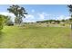 Expansive backyard featuring lush green grass, a charming shed, and serene pond views at 318 Seneca River Dr, Summerville, SC 29485