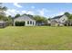 Large backyard with a well-maintained lawn, storage shed, trampoline, partial fencing, and mature trees at 318 Seneca River Dr, Summerville, SC 29485