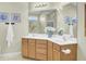 Bathroom featuring dual sinks, a large mirror, and wood cabinetry at 318 Seneca River Dr, Summerville, SC 29485