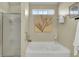 Bright bathroom with a soaking tub and separate glass enclosed shower at 318 Seneca River Dr, Summerville, SC 29485
