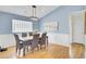 Stylish dining room with modern lighting, wainscoting, and wood floors at 318 Seneca River Dr, Summerville, SC 29485