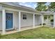 Charming home exterior features a blue front door with wreath, complemented by white pillars and a well-kept lawn at 318 Seneca River Dr, Summerville, SC 29485