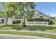 Charming home exterior featuring a well-manicured lawn, white picket fence and mature shade trees at 318 Seneca River Dr, Summerville, SC 29485